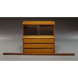 Poul Cadovius; a Danish teak wall shelving unit, 1960s, with glazed unit above three drawers,