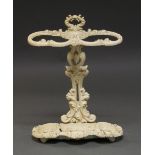 A Victorian cast iron white-painted umbrella stand decorated throughout with 'C' scrolls,