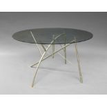 A modern glass and tubular steel table, of recent manufacture, with circular plate glass top,