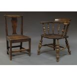 An oak hall chair, 18th century, with solid seat and vase shaped splat,