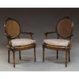 A pair of Louis XVI style beech framed fauteils, 20th century,