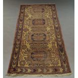 A Turkish rug with four octagons in a straw coloured field,