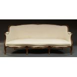 A French walnut framed three seater canape, early 20th century, with cream upholstery,