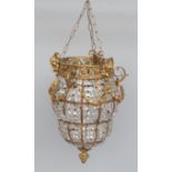 A French gilt metal hanging lantern, 20th century, the top rim moulded with ram's heads,
