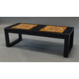 An ebonised tile top coffee table, circa 1970s, inset with eight mottled orange,
