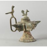 A bronze oil lamp, late 19th/20th century, possibly Chiurazzi, with domed lid with cockeral finial,