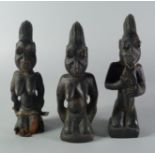 A set of three African hardwood carved kneeling figures, 20th century,