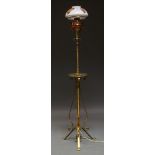 An Art Nouveau brass telescopic standard lamp with scrolling supports on tripod base and with