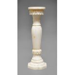 An Indian alabaster stand, 20th Century, with circular top, above foliate frieze,