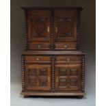 A French provincial cupboard on stand, the upper tier with double panelled doors,