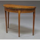 A George III mahogany and cross banded demi-lune card table, with baize lined interior,