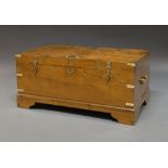 A rectangular teak and brass bound Campaign style trunk, 20th century, with brass carrying handles,