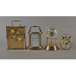 A brass and glazed oval carriage time piece, 20th century, with shaped swing handle,