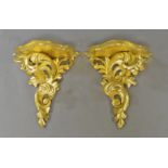 A set of four pairs of giltwood wall brackets, with shaped plateau, on foliate supports,