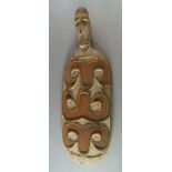 A Sepik river tribal carved dish, 20th century, of paddle shape with carved head finial,