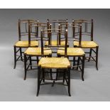 A set of six rush seated stained beech chairs, 19th century, with spindle turned backs,