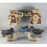 Two similar pottery elephants, 20th century, modelled wearing square form boxes on their backs,