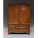 A George III mahogany linen press, with dentil moulded cornice above two doors,