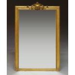 A carved gilt gesso over mantle mirror, 19th century, with scrolling pediment, modern plate,