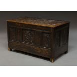 A large oak coffer, late 17th century, profusely carved throughout with foliate scrolls,