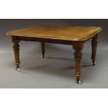 A Victorian oak extending dining table, on turned and reeded legs, on ceramic casters,