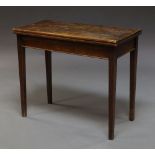 An oak foldover tea table, 18th century, the rectangular top above square tapering supports,
