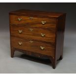 A George III mahogany chest of three long graduated drawers on tapering feet,