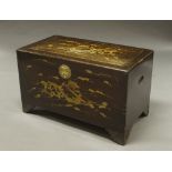 A Chinese camphor wood trunk, mid 20th century, decorated in gilt with dragons,