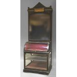 A late Victorian ebonised wood and glazed display cabinet, possibly for a Newcastle based shop,