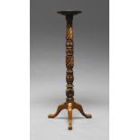 A mahogany jardiniere stand, early 20th century, with a circular top, on ornately carved stem,