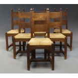 A set of six oak Arts and Crafts style dining chairs,