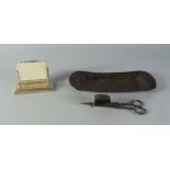 A steel candle snuffer and a toleware rectangular tray, 19th century, the tray 25.