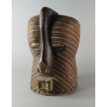 A large tribal mask, Dogon, carved with a large nose and square mouth,