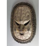 A large Sepik River carved oval mask, 20th century, with almond shaped eyes and open work mouth,