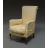 A Edwardian armchair, upholstered in yellow damask material, on cabriole legs,