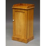 An Edwardian pine single door pot cupboard with galleried top,