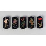 A set of five Japanese black lacquer hashi-oki (chopstick rest), 20th century, each decorated with a