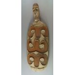 A Sepik river tribal carved dish, 20th century, of paddle shape with carved head finial, the oval