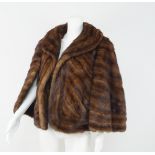 An unusual mink jacket, Henri Stern, Paris, the sleeveless jacket with arm capes and shawl collar,