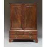 A Georgian mahogany linen press, with two panelled doors enclosing a hanging space,