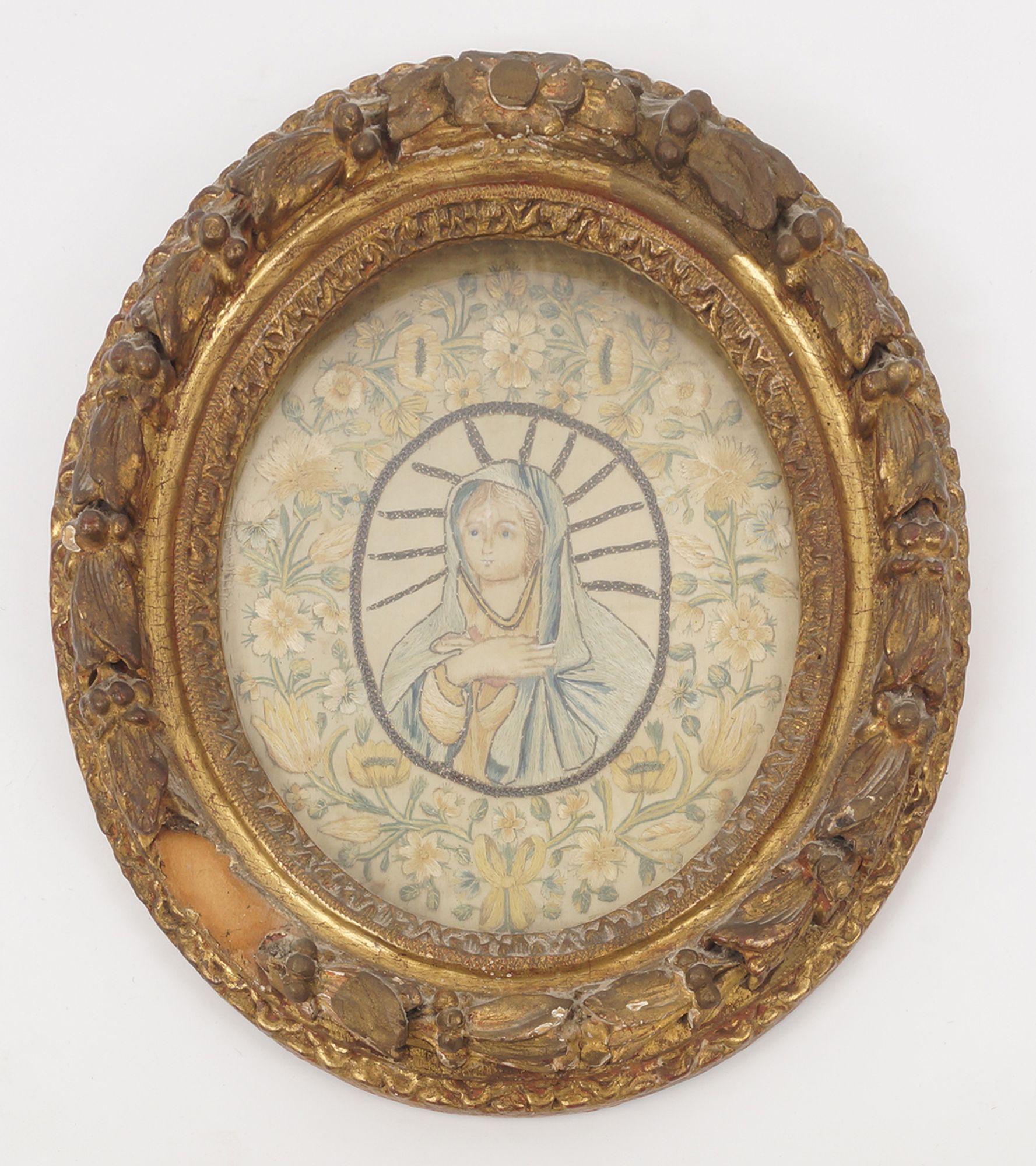 An embroidered silkwork picture of The Virgin, with floral border, in oval frame, 23.