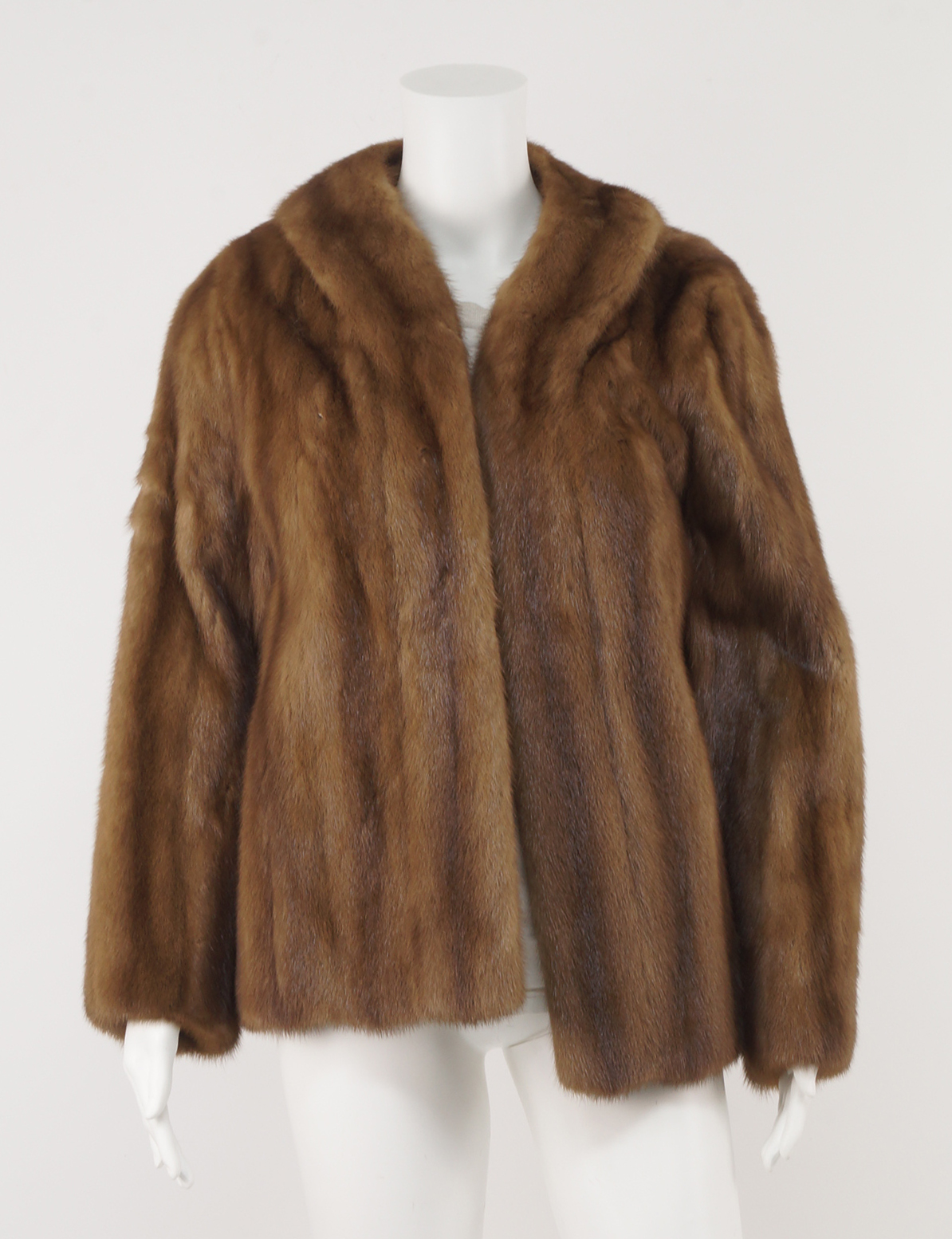 A pastel mink jacket by Calman Links, together with a racoon short jacket, an ermine jacket,