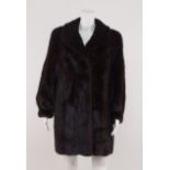 A mink jacket, rounded collar, concealed closure and sleeves gathered at the cuff,