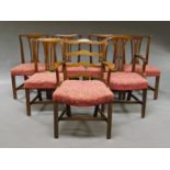 A George III style mahogany armchair, with ladder back and scrolling arms, above overstuffed seat,