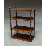 A Victorian mahogany four tier whatnot, on turned pilaster supports, (lacking feet),