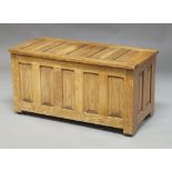 A rectangular oak coffer, 20th century, of panel construction, with lifting lid, 47cm high x 91.