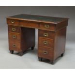 A mahogany campaign style pedestal desk, early 20th century, with inset green leather top,