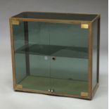 A rectangular bronzed metal and glass display cabinet, circa.