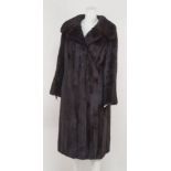 A full length dark mink coat, large collar and wide lapels, concealed front fastenings,