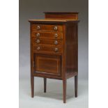 An Edwardian mahogany and cross banded music cabinet, with four drawers over single cupboard door,